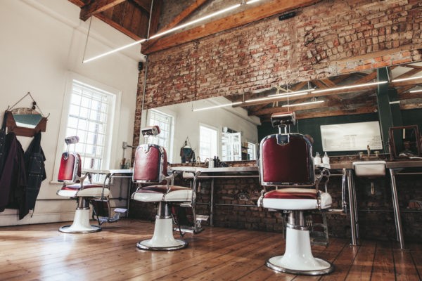 Horizontal shot of empty chairs in retro styled barbershop. Hair salon interior.